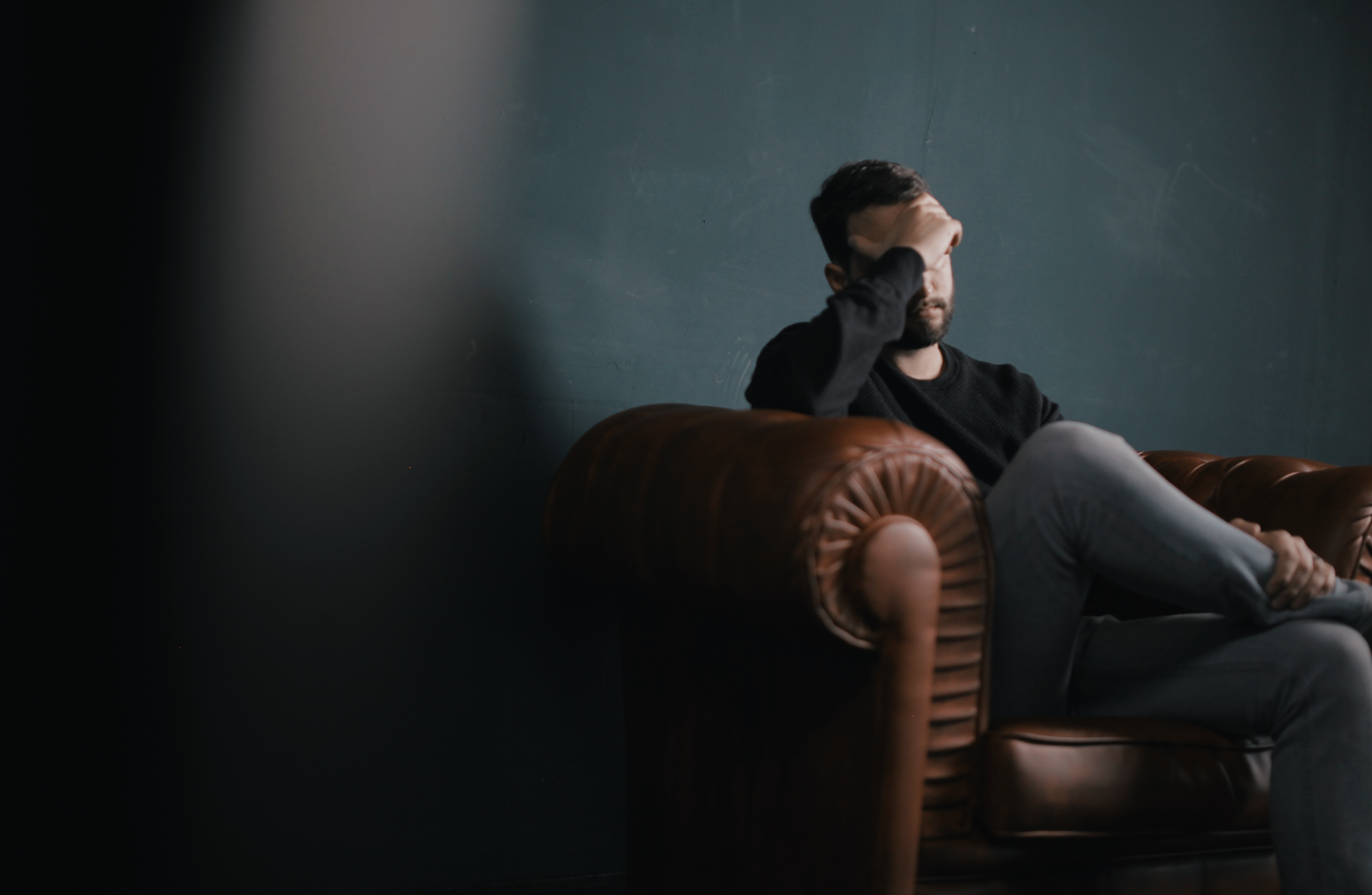 man contemplating how to apologize to someone he hurt a long time ago